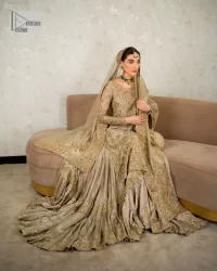 Comfy is a mood. The latest style of shirt sharara in high-quality fabric detailing with light gold gota, zari, dabka, sequence, naqshi, stones & tilla work all over the outfit. Full embellished shirt with full detailing and heavy neckline design with high-quality inner. Further, the beautiful floral motifs are adorned on sleeves to make this masterpiece super aesthetic It is coordinated with sharara with heavy embroidery on the border. The floor-length sharara gives a unique look. Complete this walima wear with a dupatta adorned with four-sided embellished frames and sequins sprayed all over.