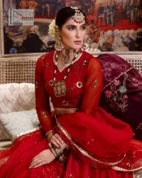 Statement suiting in red. This red blouse comes with a lehenga and dupatta in premium fabric quality. The blouse is beautifully decorated with fine embroidery work accompanied by iridescent sequins, tilla, dabka, kora and Zardozi. Furthermore, beautiful artistry on the neckline is highlighted with golden embroidery accompanied by cutwork counting more to the elegance of this luxurious attire. It is organized with a flared lehenga in the same colour. This embroidered lehenga comes is very neatly stitched and decorated with lavish embroidery and minimal floral motifs making this dreamy attire look heavenly and your ultimate priority. Complete this reception wear with a dupatta framed with four-sided embellished borders that is your favourite statement on your big day.