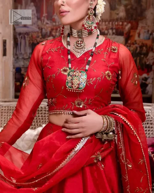 Statement suiting in red. This red blouse comes with a lehenga and dupatta in premium fabric quality. The blouse is