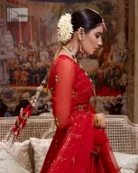 Statement suiting in red. This red blouse comes with a lehenga and dupatta in premium fabric quality. The blouse is beautifully decorated with fine embroidery work accompanied by iridescent sequins, tilla, dabka, kora and Zardozi. Furthermore, beautiful artistry on the neckline is highlighted with golden embroidery accompanied by cutwork counting more to the elegance of this luxurious attire. It is organized with a flared lehenga in the same colour. This embroidered lehenga comes is very neatly stitched and decorated with lavish embroidery and minimal floral motifs making this dreamy attire look heavenly and your ultimate priority. Complete this reception wear with a dupatta framed with four-sided embellished borders that is your favourite statement on your big day.
