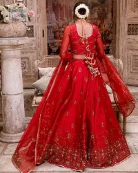 Statement suiting in red. This red blouse comes with a lehenga and dupatta in premium fabric quality. The blouse is beautifully decorated with fine embroidery work accompanied by iridescent sequins, tilla, dabka, kora and Zardozi. Furthermore, beautiful artistry on the neckline is highlighted with golden embroidery accompanied by cutwork counting more to the elegance of this luxurious attire. It is organized with a flared lehenga in the same colour. This embroidered lehenga comes is very neatly stitched and decorated with lavish embroidery and minimal floral motifs making this dreamy attire look heavenly and your ultimate priority. Complete this reception wear with a dupatta framed with four-sided embellished borders that is your favourite statement on your big day.
