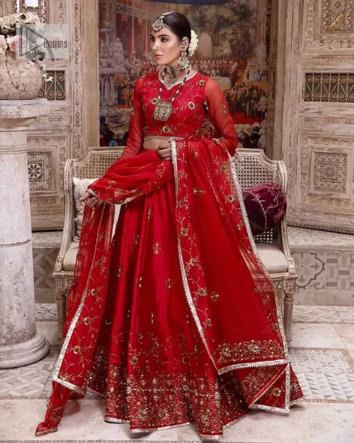 Statement suiting in red. This red blouse comes with a lehenga and dupatta in premium fabric quality. The blouse is