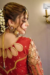 The deep orange colour is the perfect feminine and delicate shade with its meticulously crafted untruth. The stunning maxi is ornamented with tilla, dabka, kora, Kundan, Zardozi and crystals. Embroidery is done in the shade of gold.  The illusion neckline of the maxi just steals everyone's heart. Further, the full sleeves of the maxi are also decorated with geometric patterns. The frill of the following maxi gives a perfectly glamorous look to the whole reception wear. It is paired up with a dupatta which is adorned with floral motifs all over.