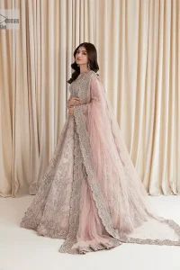 Rose Pink, is the colour of confidence on your big day. The blouse in the rose pink shade is embellished with intricate designs, silverwork, and fine details. The V shape neckline and full sleeves look perfect with the lehenga. Beautiful details of crystals, tilla, dabka, kora, stones, and dabka give a perfect finishing look to the following blouse. It is organized with a lehenga which is heavily adorned with silver embroidery to add more charm and beauty to the outfit. Complete this outfit with a dupatta framed with four-sided borders that gives an elegant look to the gorgeous bride.