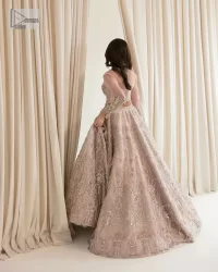 Rose Pink, is the colour of confidence on your big day. The blouse in the rose pink shade is embellished with intricate designs, silverwork, and fine details. The V shape neckline and full sleeves look perfect with the lehenga. Beautiful details of crystals, tilla, dabka, kora, stones, and dabka give a perfect finishing look to the following blouse. It is organized with a lehenga which is heavily adorned with silver embroidery to add more charm and beauty to the outfit. Complete this outfit with a dupatta framed with four-sided borders that gives an elegant look to the gorgeous bride.