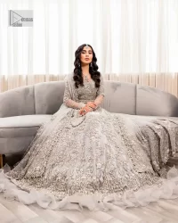 Enter the world of allurement with steel grey, a gorgeous go-to dress for nikah to make you look classy and fabulous at the same time! The delicate details of this gorgeous bridal dress are from exquisite patterns observed in silver embroidery which is prominent with tilla, dabka, kora, Kundan, Zardozi and the real magic of crystals. The house has V shape neckline to make this masterpiece a little romantic and classy. Further, full sleeves are fully designed with fantastic floral patterns spread all over. It is paired with a lehenga having frilled to complete the lavish look of this fully embellished nikah wear. Complete this article with a dupatta adorned with four-sided embellished borders and sequins sprayed all over.