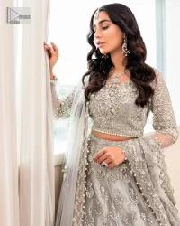Enter the world of allurement with steel grey, a gorgeous go-to dress for nikah to make you look classy and fabulous at the same time! The delicate details of this gorgeous bridal dress are from exquisite patterns observed in silver embroidery which is prominent with tilla, dabka, kora, Kundan, Zardozi and the real magic of crystals. The house has V shape neckline to make this masterpiece a little romantic and classy. Further, full sleeves are fully designed with fantastic floral patterns spread all over. It is paired with a lehenga having frilled to complete the lavish look of this fully embellished nikah wear. Complete this article with a dupatta adorned with four-sided embellished borders and sequins sprayed all over.