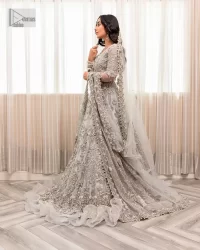 Enter the world of allurement with steel grey, a gorgeous go-to dress for nikah to make you look classy and fabulous at the same time! The delicate details of this gorgeous bridal dress are from exquisite patterns observed in silver embroidery which is prominent with tilla, dabka, kora, Kundan, Zardozi and the real magic of crystals. The house has V shape neckline to make this masterpiece a little romantic and classy. Further, full sleeves are fully designed with fantastic floral patterns spread all over. It is paired with a lehenga having frilled to complete the lavish look of this fully embellished nikah wear. Complete this article with a dupatta adorned with four-sided embellished borders and sequins sprayed all over.