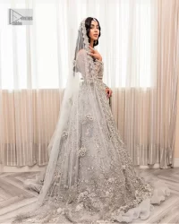 Enter the world of allurement with steel grey, a gorgeous go-to dress for nikah to make you look classy and fabulous at the same time! The delicate details of this gorgeous bridal dress are from exquisite patterns observed in silver embroidery which is prominent with tilla, dabka, kora, Kundan, Zardozi and the real magic of crystals. The house has V shape neckline to make this masterpiece a little romantic and classy. Further, full sleeves are fully designed with fantastic floral patterns spread all over. It is paired with a lehenga having frilled to complete the lavish look of this fully embellished nikah wear. Complete this article with a dupatta adorned with four-sided embellished borders and sequins sprayed all over.