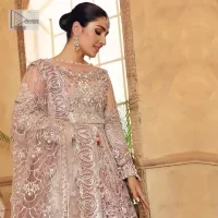 This elegantly poised ensemble defines nikah fashion in its most refined form! The scalloped maxi in premium quality is hand-embellished with beaming adornments and multiple colour embroidery. It is further enhanced with tilla, dabka, kora, Kundan and the real magic of crystals. Stunning designs on full sleeves and premium details on the illusion neckline make it an exquisite masterpiece. It is combined with sharara to balance the most demanding and delicate look. Finish this nikah wear with a dupatta in the same colour. The borders of this dupatta are heavily embellished, giving a perfectly glamorous look to the beautiful attire.