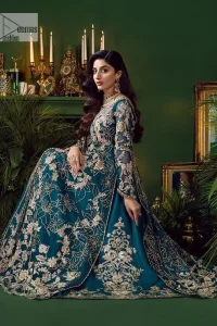 Let the outfit speak for itself! DeemasFashion presents this party wear in teal blue colour.  Be a centre of attraction by donning this beautiful teal blue long shirt embellished with tilla, dabka, kora, Kundan and sequins work which is further intensified with silver and golden embroidery. The shirt is emphasized with a sweetheart neckline and full sleeves to make your day super romantic. It is organized with a lehenga which is embellished with embroidered floral motifs to explain the love of the bride. To finish this article, the last but not least piece comes that is the dupatta which is adorned with four-sided heavily embellished borders and sequins spray that accentuates the whole look.