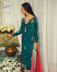 Brighten up your day with this beautiful ensemble. This long shirt style in a teal green colour is a perfect outfit that gives you a royal look on the festive occasion. The embroidered neckline and full sleeves make this outfit an epitome of beauty. Further, Embroidery work which enhances with tilla, dabka, kora, Kundan and lavish designs makes this outfit your priority for the day. It is paired with plum trousers which have finished edges to balance the overall look of the day. Complete this party wear with a dupatta in pink colour sparkling sequins spray all over. 