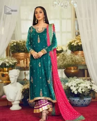 Brighten up your day with this beautiful ensemble. This long shirt style in a teal green colour is a perfect outfit that gives you a royal look on the festive occasion. The embroidered neckline and full sleeves make this outfit an epitome of beauty. Further, Embroidery work which enhances with tilla, dabka, kora, Kundan and lavish designs makes this outfit your priority for the day. It is paired with plum trousers which have finished edges to balance the overall look of the day. Complete this party wear with a dupatta in pink colour sparkling sequins spray all over. 