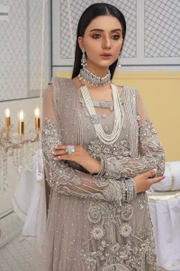 Chill vibes in grey are very rare. A beautiful grey shirt with a medley of hand-embellished floral motifs and floral patterns of silver embroidery which is highlighted with tilla, dabka, kora, Kundan and the real magic of Zardozi. The illusion neckline makes this party outfit a little romantic. Further, the floral patterns on full sleeves also add super beauty. It is paired up with plain jamawar trousers just to balance the look   Complete this gorgeous outfit with a dupatta in the same colour framed with four-sided borders and sequins sprayed all over. 