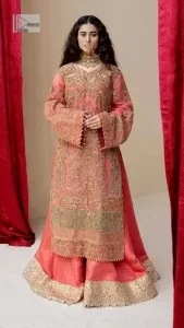 It's an aesthetic kinda mood. The long shirt in the wondrous peach colour is composed of ethnic handworked details and gleaming embellishments rendered artistically on a Jamawar canvas. The long shirt is layered with embroidered details with an enhanced V neckline and borders. The beautiful shirt is prominent with tilla, dabka, kora, Kundan and Zardozi in gold colour. Further, the intricate floral patterns on full sleeves make this outfit crazier. Complementing the shirt with gharara with elaborated borders depicts a perfect contemporary vibe.
