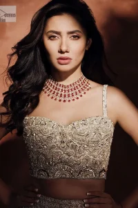 Chill vibes on your big day with this walima outfit. A soft pink blouse is embellished in tilla,dabka, kora, Kundan and crystals with a fish cut style lehenga with a huge trail at the back. The blouse has a sweetheart neckline to make this outfit romantic. Further, the blouse is embellished with silver embroidery just to make you a spotlight of the show. The sleeveless style makes this masterpiece unique and lovely. It is paired up with a fish-cut lehenga in the same colour. The heavy bak train lehenga is adorned with embroidery making a bride look more regal than a costume.