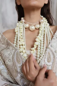 Get this ever-trending floral walima outfit.  Keep it romantic and fantastic with the DeemasFashion latest articles! The soft green blouse is gracefully embellished with silver and gold embroidery that gives you a head-turning appearance on the wedding day. The blouse is enhanced with tilla, dabka, kora, Kundan, and crystals. The off-shoulder neckline of the blouse makes this stunning attire an epitome of royalty and grace. It is paired with a flared lehenga that is also adorned with embroidery to make your day fantastic. Complete this article with a dupatta framed with four-sided embellished borders and sequins sprayed all over.