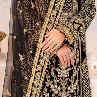 Intricate floral patterns all over! Make a style statement with this elegant embroidered long shirt adorned with golden embroidery decorated with sequins, tilla, dabka, kora, Kundan, heavily embellished bodice, and floral bunches. The round neckline of the following shirt makes this article stunning and charming. The full sleeves of the shirt are also magnified with floral motifs. It is paired up with trousers in the same colour to balance the overall look of this party wear. Complete this outfit with a dupatta framed with four-sided borders and tiny floral motifs all over which is exactly a pure trendy style.