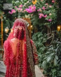 Classic deep red canvas with a bold twist of the pattern!  Bridal choli in the deep red shade is a beautiful attire to wear on the big day to have an elegant and classy look. This beautiful choli is heavily embellished with crystals, pearls, dabka,tilla, kora, Kundan, stones, and Zardozi giving a magnificent touch to the lehenga choli. The round neckline of the attractive blouse makes an outfit look more sophisticated. Further, the beautiful floral patterns on three-quarter sleeves make this outfit a must-have for your day. It is paired with a heavily embellished lehenga and is a stylish choice for the gorgeous Bride. Complete this romantic article with a dupatta framed with four-sided embellished borders and sequins sprayed all over.