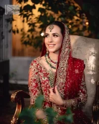 Classic deep red canvas with a bold twist of the pattern!  Bridal choli in the deep red shade is a beautiful attire to wear on the big day to have an elegant and classy look. This beautiful choli is heavily embellished with crystals, pearls, dabka,tilla, kora, Kundan, stones, and Zardozi giving a magnificent touch to the lehenga choli. The round neckline of the attractive blouse makes an outfit look more sophisticated. Further, the beautiful floral patterns on three-quarter sleeves make this outfit a must-have for your day. It is paired with a heavily embellished lehenga and is a stylish choice for the gorgeous Bride. Complete this romantic article with a dupatta framed with four-sided embellished borders and sequins sprayed all over.