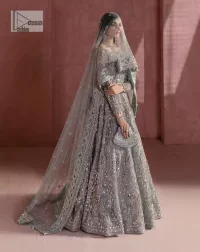 A timelessly classic and hot Nikah wear. DeemasFashion presents the flared maxi in grey colour which is heavily adorned with silver embroidery which is prominent with tilla, dabka, Kora, Kundan and the details of crystals. The boat shape neckline gives a super glamorous touch to the outfit. in addition to this, the floral patterns on full sleeves make this article lovely and romantic. A perfect outfit for an everlasting majestic look is paired up with a dupatta in the same colour framed with four-sided embellished borders and tiny floral motifs all over to give it a perfect royal look.