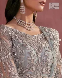 A timelessly classic and hot Nikah wear. DeemasFashion presents the flared maxi in grey colour which is heavily adorned with silver embroidery which is prominent with tilla, dabka, Kora, Kundan and the details of crystals. The boat shape neckline gives a super glamorous touch to the outfit. in addition to this, the floral patterns on full sleeves make this article lovely and romantic. A perfect outfit for an everlasting majestic look is paired up with a dupatta in the same colour framed with four-sided embellished borders and tiny floral motifs all over to give it a perfect royal look.