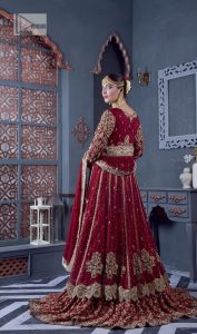 Bold and classy colour for the reception outfit! The maroon gown is breathtakingly adorned with hand-crafted embellishments and intricate designs. It is enhanced with tilla, dabka, Koran, Kundan and details of Zardozi. The round neckline is emblazoned with golden embroidery to make this masterpiece romantic. The full sleeves of the following scalloped gown are adorned with fine details. It is paired with flared lehenga which is also heavily embellished giving a royal look to the gorgeous bride. Finish this maroon outfit with a dupatta which is ornamented with four-sided borders and sequins sprayed all over to create an exquisite dress.