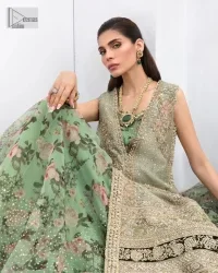 The timelessly classic mint green nikah outfit! The beautiful model looks ravishing in this mint green shirt, heavily hand-embellished with floral motifs and sequins spray. The back of the shirt is sprayed with sequins and has an embellished border; an embellished front and back panel border makes this outfit unique. The V shape neckline adds super beauty to the outfit which involves tilla, dabka, kora, Kundan and the real magic of crystals. Further, the sleeveless style is for extra comfort zone. It is paired with a flared lehenga with an intricately embellished border. 