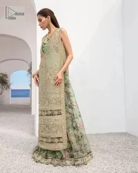The timelessly classic mint green nikah outfit! The beautiful model looks ravishing in this mint green shirt, heavily hand-embellished with floral motifs and sequins spray. The back of the shirt is sprayed with sequins and has an embellished border; an embellished front and back panel border makes this outfit unique. The V shape neckline adds super beauty to the outfit which involves tilla, dabka, kora, Kundan and the real magic of crystals. Further, the sleeveless style is for extra comfort zone. It is paired with a flared lehenga with an intricately embellished border. 