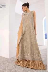 The silver and golden embroidery is the highlight of the party outfit! Keep it dreamy and classic with DeemasFashion. The handsome light orange long shirt is gracefully embellished with silver and gold embroidery that gives you a head-turning appearance on the wedding day. The shirt is enhanced with tilla, dabka, kora, Kundan, and crystals. The round neckline of the shirt makes this glamorous attire an epitome of royalty and grace. It is paired up with crushed sharara to make this masterpiece unique.  A light orange dupatta has a sequin-sprayed surface with branching tiny floral motifs all over. The beautifully embellished border envelopes the dupatta.