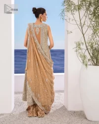 The silver and golden embroidery is the highlight of the party outfit! Keep it dreamy and classic with DeemasFashion. The handsome light orange long shirt is gracefully embellished with silver and gold embroidery that gives you a head-turning appearance on the wedding day. The shirt is enhanced with tilla, dabka, kora, Kundan, and crystals. The round neckline of the shirt makes this glamorous attire an epitome of royalty and grace. It is paired up with crushed sharara to make this masterpiece unique.  A light orange dupatta has a sequin-sprayed surface with branching tiny floral motifs all over. The beautifully embellished border envelopes the dupatta.