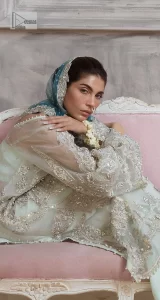 It’s bright, it's bold, it’s crosshatch. DeemasFashion presents the soft green and teal blue combo party outfit. The long shirt is heavily adorned with tilla,dabka, Kora, Kundan and the magical details of Zardozi. It is prominent with fine details of silver embroidery. The V neckline has delicate handwork to enhance the masterpiece. Further, the full sleeves also add super beauty to the outfit. It is paired up with plain trousers and a blouse to balance the overall outfit so that you are just the shining star of the show. Complete this handsome look with teal blue dupatta which is embellished with four-sided borders and sequins sprayed all over.