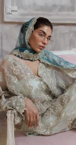 It’s bright, it's bold, it’s crosshatch. DeemasFashion presents the soft green and teal blue combo party outfit. The long shirt is heavily adorned with tilla,dabka, Kora, Kundan and the magical details of Zardozi. It is prominent with fine details of silver embroidery. The V neckline has delicate handwork to enhance the masterpiece. Further, the full sleeves also add super beauty to the outfit. It is paired up with plain trousers and a blouse to balance the overall outfit so that you are just the shining star of the show. Complete this handsome look with teal blue dupatta which is embellished with four-sided borders and sequins sprayed all over.