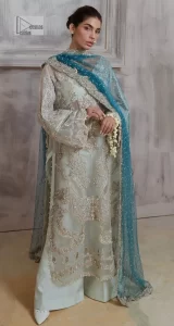 It’s bright, it's bold, it’s crosshatch. DeemasFashion presents the soft green and teal blue combo party outfit. The long shirt is heavily adorned with tilla,dabka, Kora, Kundan and the magical details of Zardozi. It is prominent with fine details of silver embroidery. The V neckline has delicate handwork to enhance the masterpiece. Further, the full sleeves also add super beauty to the outfit. It is paired up with plain trousers and a blouse to balance the overall outfit so that you are just the shining star of the show. Complete this handsome look with teal blue dupatta which is embellished with four-sided borders and sequins sprayed all over.