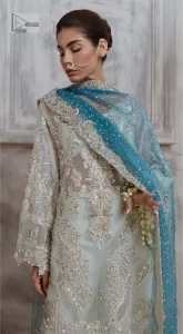 It’s bright, it's bold, it’s crosshatch. DeemasFashion presents the soft green and teal blue combo party outfit. The long shirt is heavily adorned with tilla,dabka, Kora, Kundan and the magical details of Zardozi. It is prominent with fine details of silver embroidery. The V neckline has delicate handwork to enhance the masterpiece. Further, the full sleeves also add super beauty to the outfit. It is paired up with plain trousers and a blouse to balance the overall outfit so that you are just the shining star of the show. Complete this handsome look with teal blue dupatta which is embellished with four-sided borders and sequins sprayed all over.