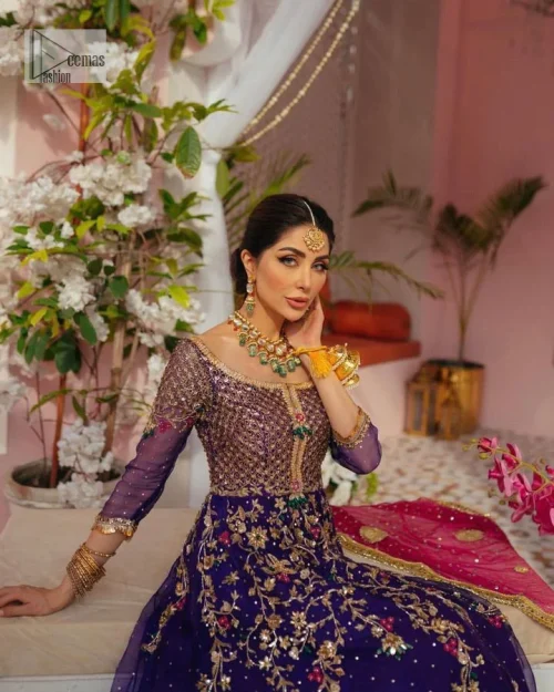 Slay your mehndi looks with signature statement pieces. This stunning plum frock is gracefully emblazoned with tilla, dabka, kora, Kundan,