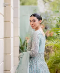 The fused lehenga is offered in a rich, sophisticated colour palette, ensuring you steal the spotlight with your regal presence. Finish this article with a dupatta framed with four-sided embellished borders and sequins spray.