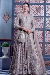 Tea Pink are always the hot trend for the walima outfit. Traditional designs and hand-crafted embellishments of the following maxi give a magnificent look to this perfect outfit. It is adorned with silver embroidery which involves tilla, dabka, Kora, Kundan and the real magic of crystals. The boat shape neckline has fine details and intricate designs. Further, the style of the three-quarter sleeves makes this masterpiece super stunning. It is paired with a lehenga in the same colour which is plain to balance the overall charm of the outfit. Finish this article with a dupatta which has an intricate embellished design on borders and sequins spray all over to make this dress a chic masterpiece.