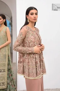 Rich shades and stunning details of party outfit – you’ll be making heads turn. A 2 pc outfit with a short front open shirt, full sleeves with floral pattern and embellishments on organza fabric; the asymmetrically placed designs are studded with golden and silver embroidery which is further highlighted with tilla, dabka, kora, Kundan and the intricate details of Zardozi. The embellished neckline has the finest details. It is paired up with the inner shirt that is also embellished to make this luxury attire unique. To complete the outfit the plain lehenga paired, just to fulfil your diva look.