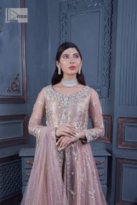 Have style and warmth with this tea rose nikah outfit! The front open maxi is the magic of floral motifs with engaging embellishments on the jamawar fabric, making this an eye-catching ensemble. The following maxi is adorned with tilla, dabka, Kora, Kundan and the real magic of Zardozi. The timeless silhouette is crafted, with floral motifs. The silver embellishments give a glamorous touch to this exquisite attire. In addition to this, the full sleeves are also decorated with floral motifs to make this article bright and charming. The round neckline also adds beauty to the overall look. Finish this article with a dupatta adorned with a four-sided borders and sequins sprayed all over for a perfect and classy look.