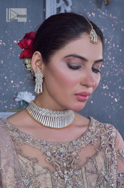 Create warm memories with this super soft and enticing tea rose nikah outfit. The vibrant shade of this maxi makes it an alluring choice for the bride. Hand-crafted adornments and designs which involve tilla, dabka, kora, Kundan and Zardozi make this attire an epitome of beauty and royalty. The round neckline of the following maxi is enhanced with silver and golden embroidery. Further, the sleeves are adorned with floral motifs to highlight the charms. The elaborately detailed border and sequin spray on the organza dupatta makes the costume ideal for your bug day.