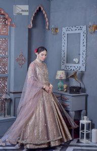 Create warm memories with this super soft and enticing tea rose nikah outfit. The vibrant shade of this maxi makes it an alluring choice for the bride. Hand-crafted adornments and designs which involve tilla, dabka, kora, Kundan and Zardozi make this attire an epitome of beauty and royalty. The round neckline of the following maxi is enhanced with silver and golden embroidery. Further, the sleeves are adorned with floral motifs to highlight the charms. The elaborately detailed border and sequin spray on the organza dupatta makes the costume ideal for your bug day.