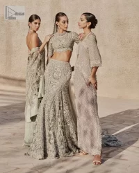 This fusion of floral embroidery is total fashion goodness for a walima outfit! A stunning teal grey organza choli embellished with intricate detailing finished with a scalloped border. The beautiful blouse is decorated with silver embellishment which is further prominent with tilla,daka, kora, Kundan and the real magic of Zardozi.  It is paired with a heavily embellished back-train lehenga with botanical motifs and geometric patterns. Its dupatta is made from a net. The dupatta is a wide embellished border that added divine charm to the entire ensemble.