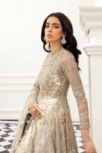 Bright nikah outfits are a constant ongoing trend! Take your look to the next level with this ivory scalloped maxi having silver and golden embellishment frames. The following maxi is highlighted with tilla, dabka, kora, Kundan, and the beautiful details of Zardozi. The jewel neckline reveals layers of priority. Furthermore, the floral patterns on full sleeves look like a complete diva.  The beautiful dupatta is framed with a floral scalloped border on all sides to give a vibrant and soft look.