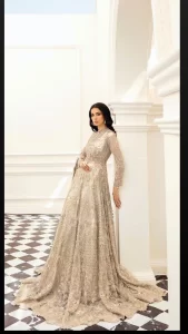 Bright nikah outfits are a constant ongoing trend! Take your look to the next level with this ivory scalloped maxi having silver and golden embellishment frames. The following maxi is highlighted with tilla, dabka, kora, Kundan, and the beautiful details of Zardozi. The jewel neckline reveals layers of priority. Furthermore, the floral patterns on full sleeves look like a complete diva.  The beautiful dupatta is framed with a floral scalloped border on all sides to give a vibrant and soft look.