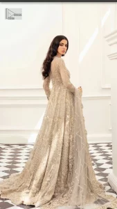 Bright nikah outfits are a constant ongoing trend! Take your look to the next level with this ivory scalloped maxi having silver and golden embellishment frames. The following maxi is highlighted with tilla, dabka, kora, Kundan, and the beautiful details of Zardozi. The jewel neckline reveals layers of priority. Furthermore, the floral patterns on full sleeves look like a complete diva.  The beautiful dupatta is framed with a floral scalloped border on all sides to give a vibrant and soft look.