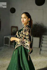 Style. Warmth. Performance & versatility!  This stuns in a beautifully handcrafted green top enshrined with light golden embellishment and detailed intricate floral & geometric patterns. The round neckline enhances the beauty of the outfit. Further, the floral designs on the sleeves make this outfit unique and attractive. It is coordinated with a plain organza lehenga in the same colour to balance your overall outfit. Collectively, this ensemble is the true essence of DeemasFashion bridals.