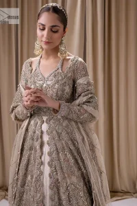 Make a statement with a light fawn article on your nikah day! DeemasFashion presents the light fawn heavy maxi which is embellished with silver embroidery using dabka, tilla, kora, Zardozi, Swarovski, Mukesh, sequin and Kundan. The strap neckline adds a little romanticness to the dress. Further, the floral patterns on full sleeves make this masterpiece modern and unique. It is paired with a  lehenga, embellished with a delicate border. It is styled with a dupatta; its surface is sprayed with sequin and the dupatta is enveloped by a heavily embellished floral border.