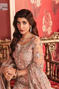 The beautiful outfit comes has an alluring peach colour and is gracefully emblazoned with embroidery. Hand-crafted details of tilla, dabka, kora, Kundan, stones, motifs, and sequins enhance the charm of this outfit. The sweetheart neckline makes this blouse a little more romantic for your walima day. Further, the floral motifs on half sleeves are just a new trend of looming on your day. It is organized with a heavy lehenga. Beaming silver work, floral designs, and lavish details give a perfect finishing look to the masterpiece. Complete this attire with a dupatta framed with a four-sided borders and floral motifs all over.