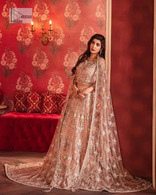 The beautiful outfit comes has an alluring peach colour and is gracefully emblazoned with embroidery. Hand-crafted details of tilla, dabka,